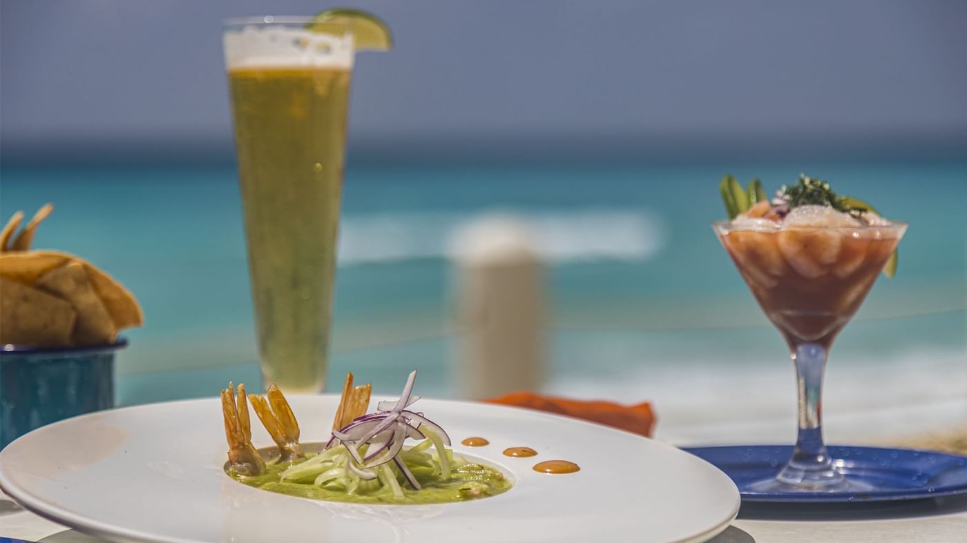 A dish served with drinks by the pool at FA Hotels & Resorts