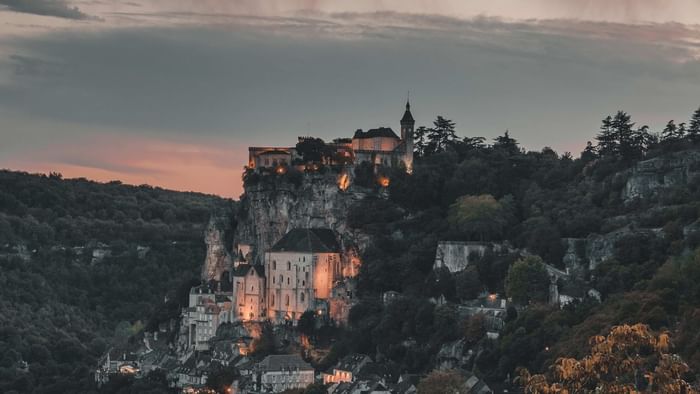 Aerial view of Rocamadour City near Originals Hotels at night
