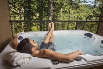 Man taking a leisurely break in a hot tub at Carson Hot Springs