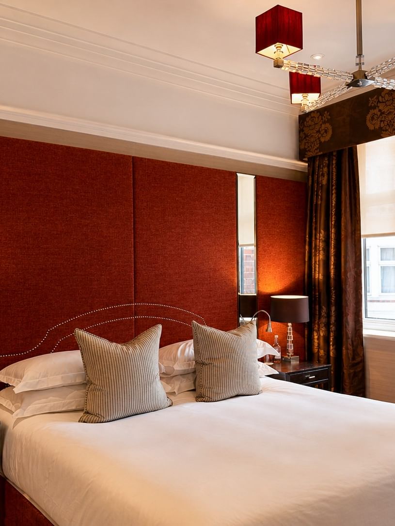 Deluxe King room with large bed, cozy decor, and modern amenities at The Capital Hotel, Apartments & Townhouse - London.
