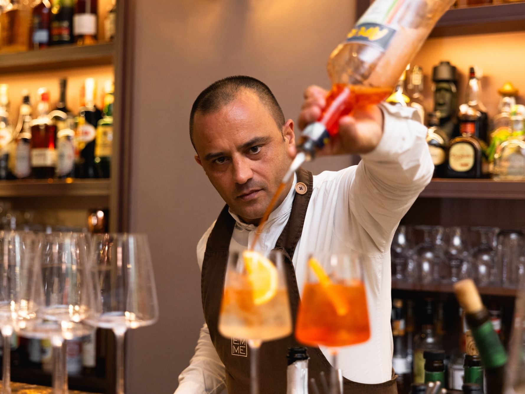 A bartender pours a cocktail into a glass in the Bar at Margutta 19