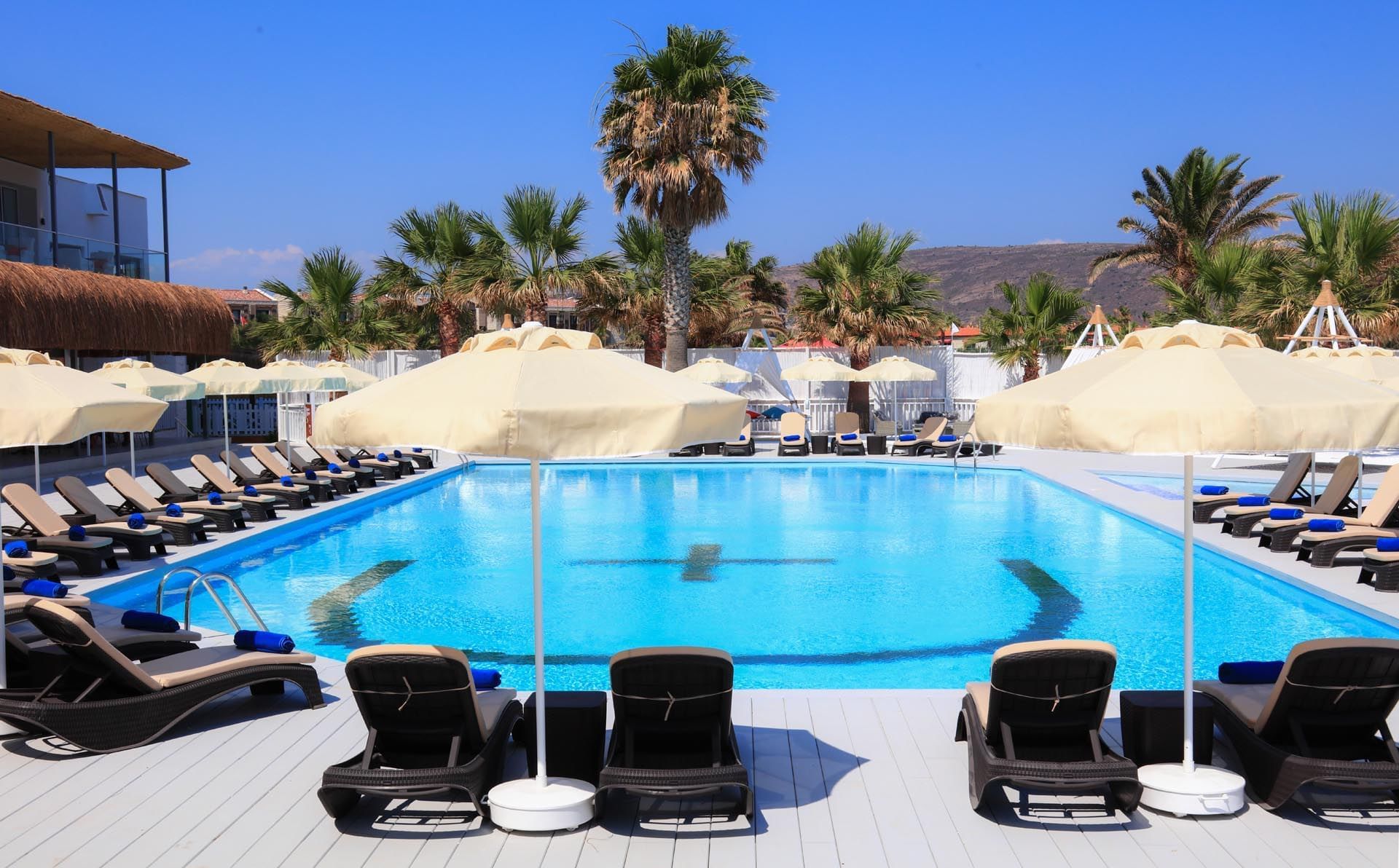 Pool area with pool chairs at Design Plus Seya Beach Hotel