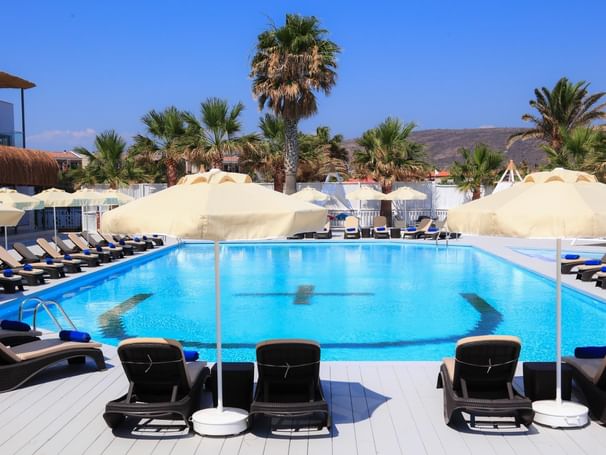 Pool area with pool chairs at Design Plus Seya Beach Hotel
