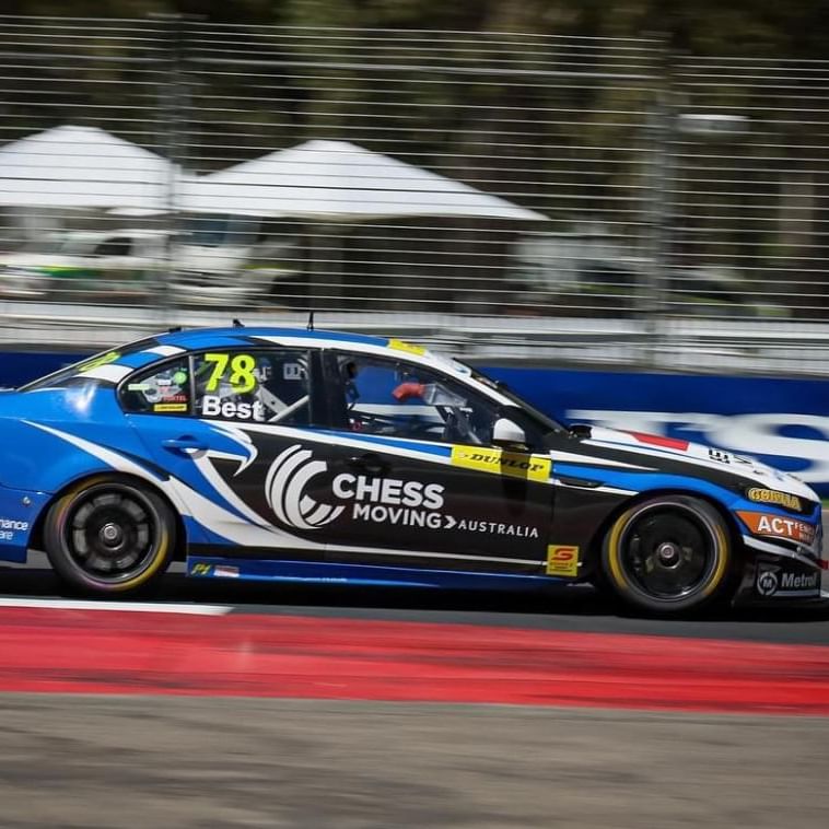 Supercars racing through the iconic Adelaide Street Circuit surrounded by cheering fans and city skyline