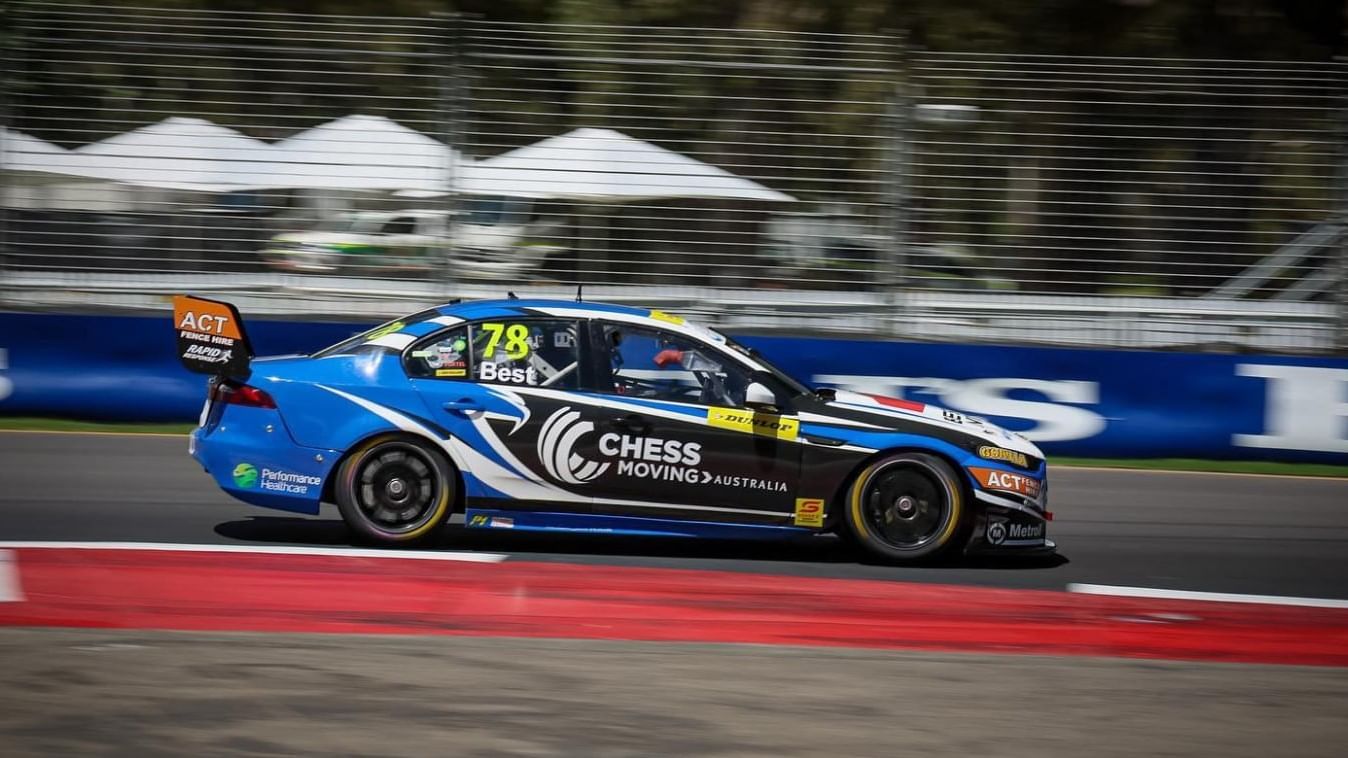 Supercars racing through the iconic Adelaide Street Circuit surrounded by cheering fans and city skyline