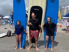 Lifeguard & students holding surfboards near our Wildwood Crest NJ hotel 