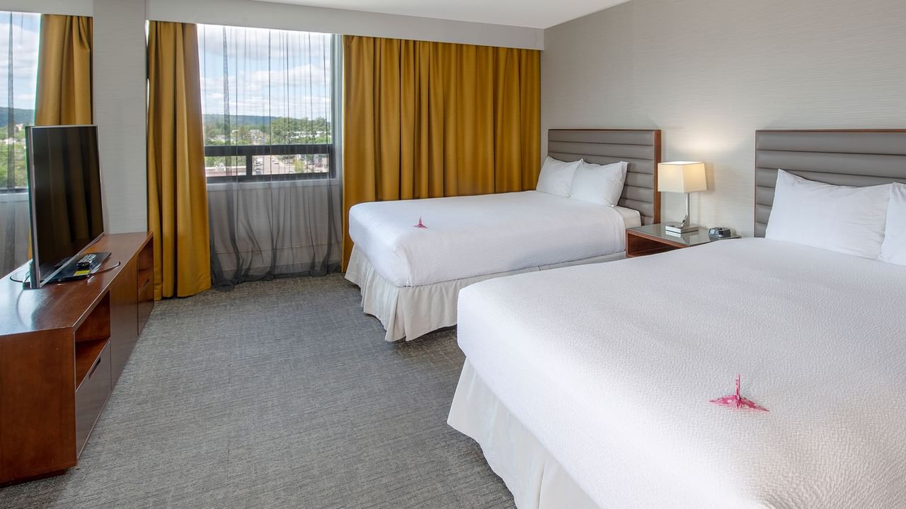 Two queen beds in a hotel suite.