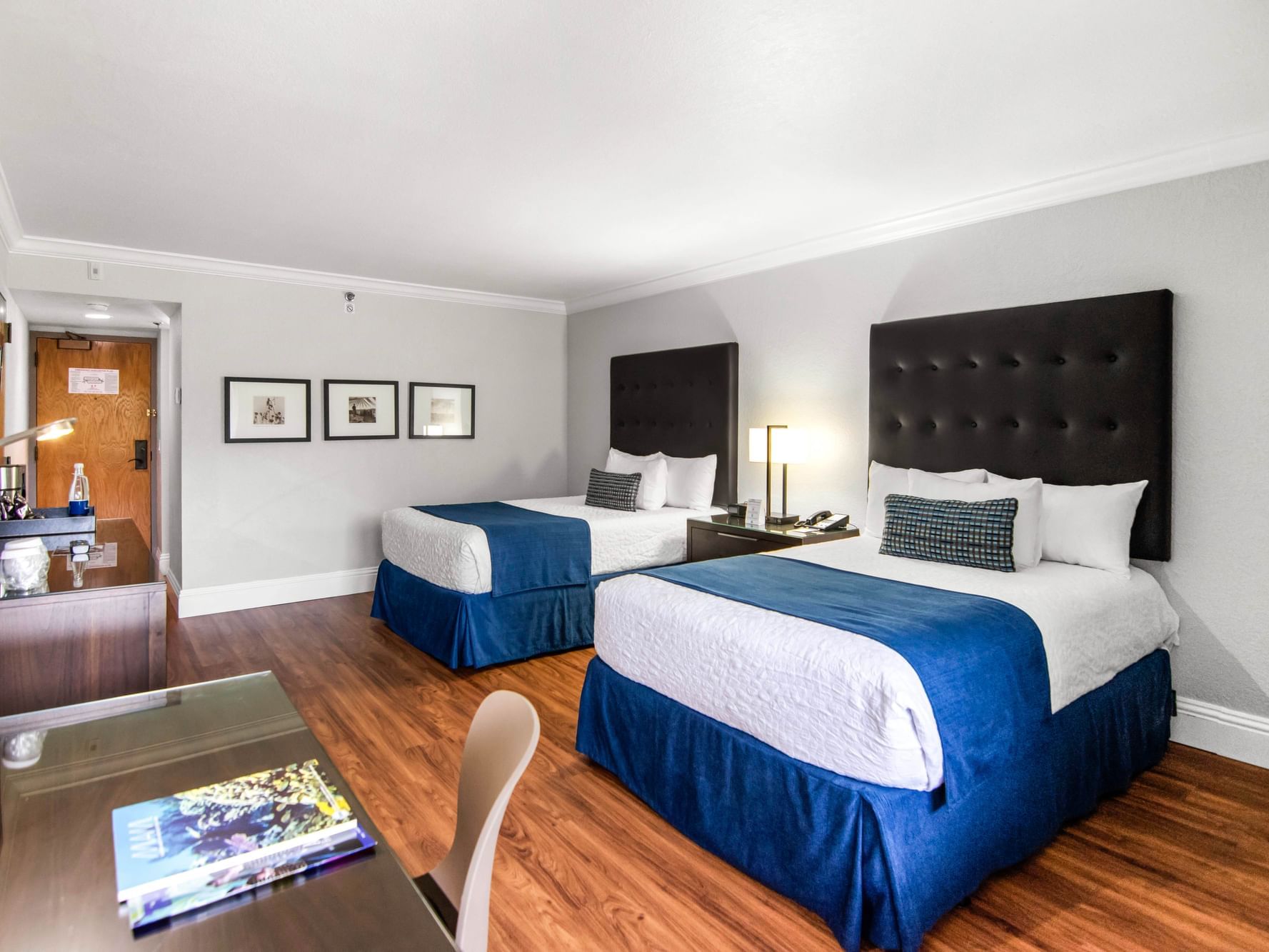 Double beds and work area in Accessible Deluxe Room with wooden floors at Miami Lakes Hotel