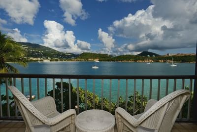 Two wicker chairs facing the bay in St Thomas hotel with ocean view rooms near Cyril E. King at Lindbergh Bay Hotel & Villas