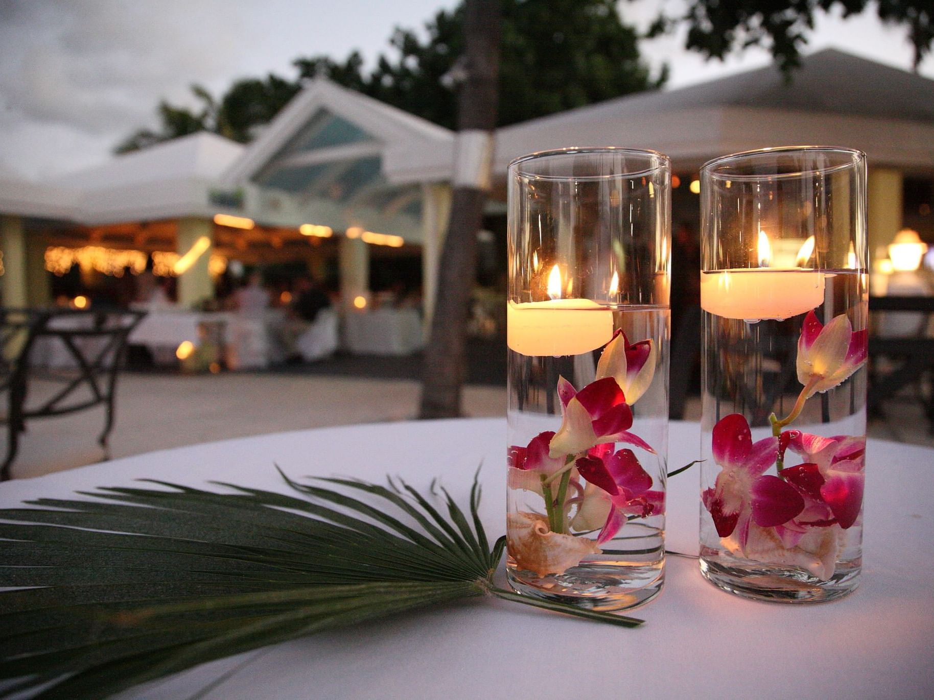 Centerpieces with floating candles and palm leaf at Tamarind Reef Resort 
