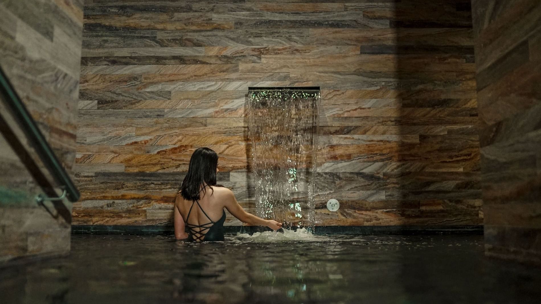 Woman in black swimsuit swimming in pool at Live Aqua San Miguel de Allende