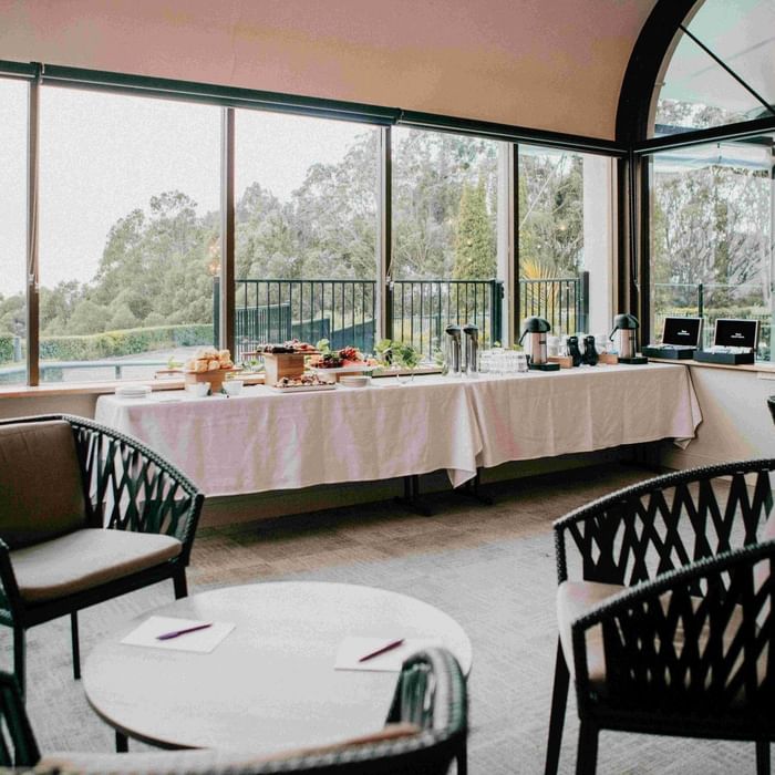 Coffee station with pastries and chairs at Mercure Charlestown.