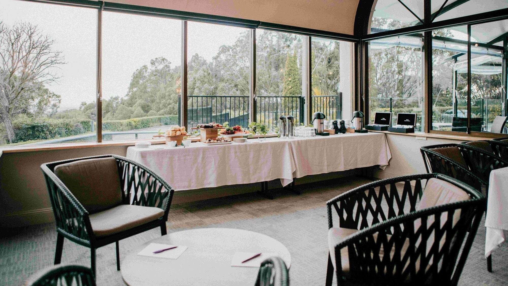 Coffee station with pastries and chairs at Mercure Charlestown.