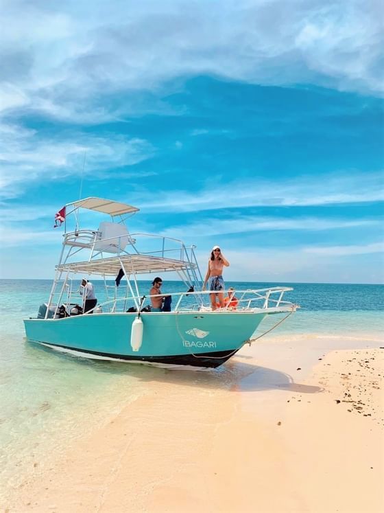 A boat with guests by the shore at Ibagari Boutique Hotel