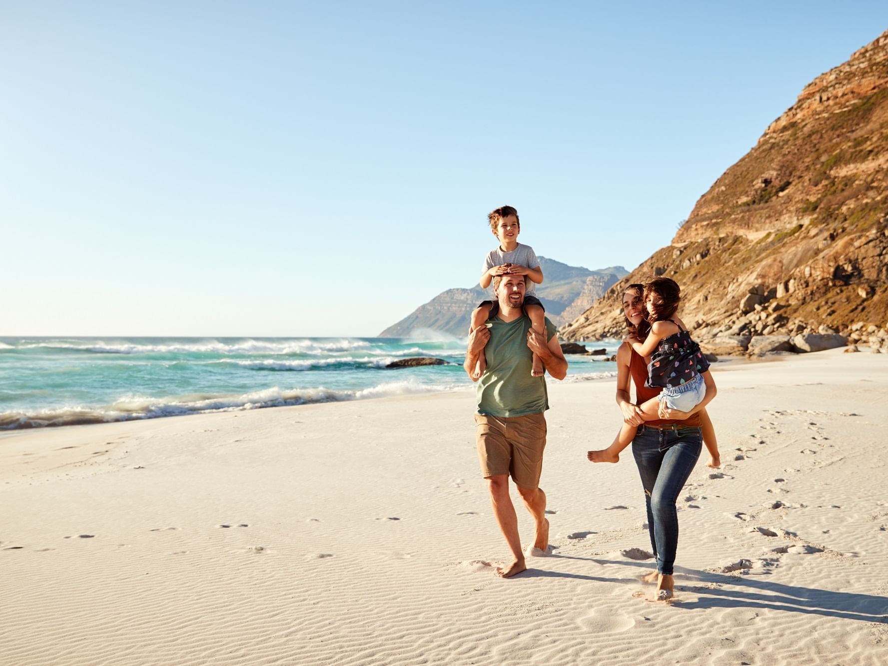 A family roaming around the beach near Originals Hotels