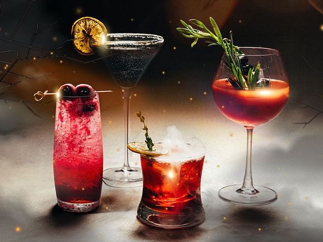  Three distinct cocktails displayed in elegant glasses, showcasing vibrant colors and garnishes for a refreshing.