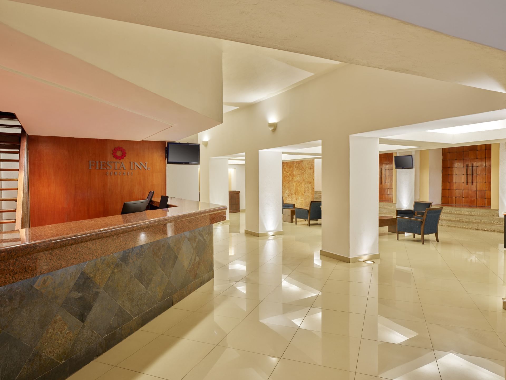 Reception counter & seating area in the lobby at Fiesta Inn