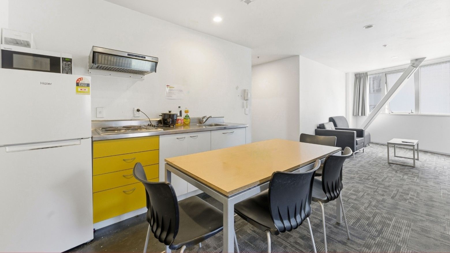 A dining area with a table and chairs in a living space at Student Living Auckland Anzac.