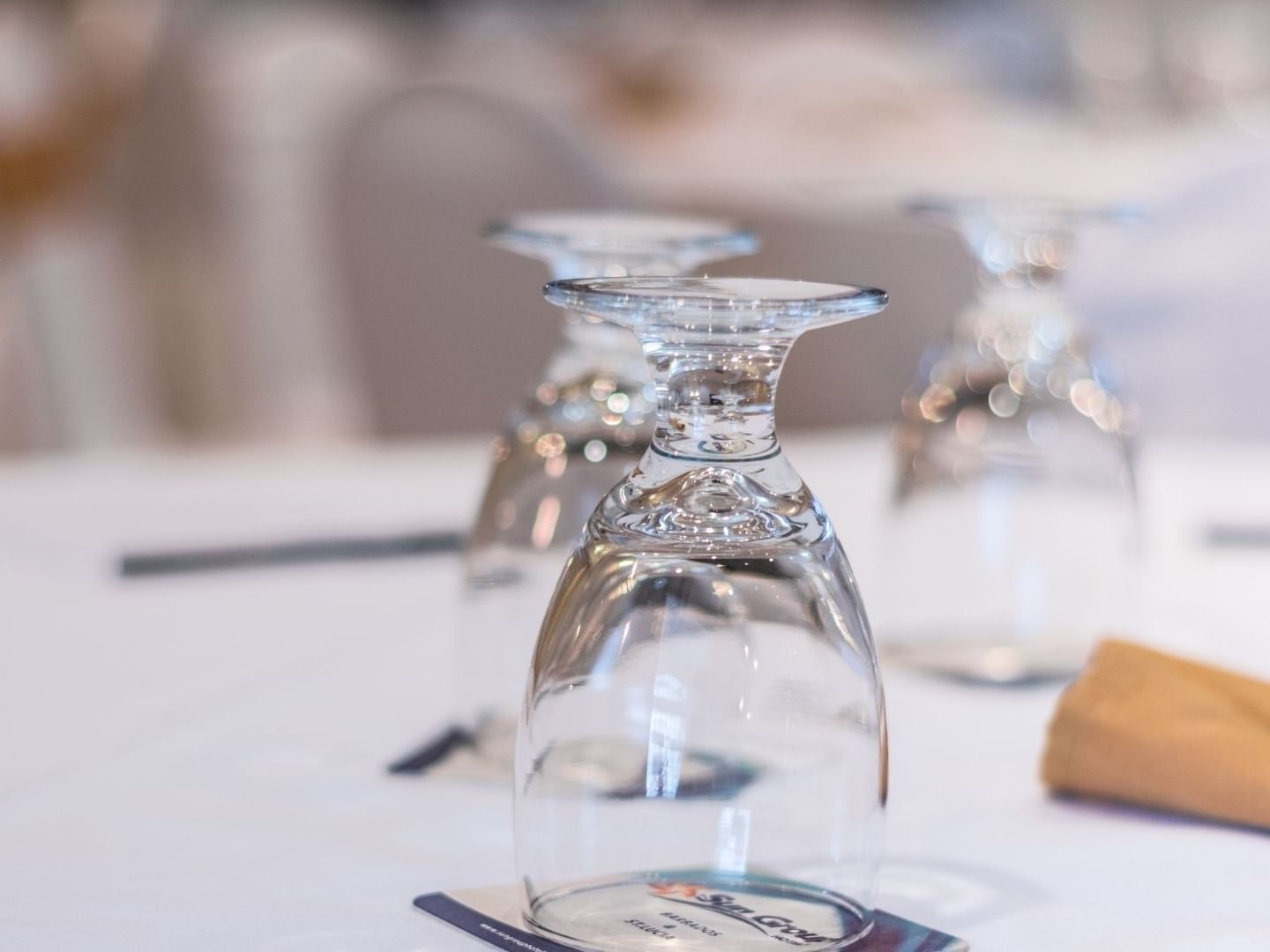 Empty glasses and a rolled napkin on a table at Savannah Beach Hotel.