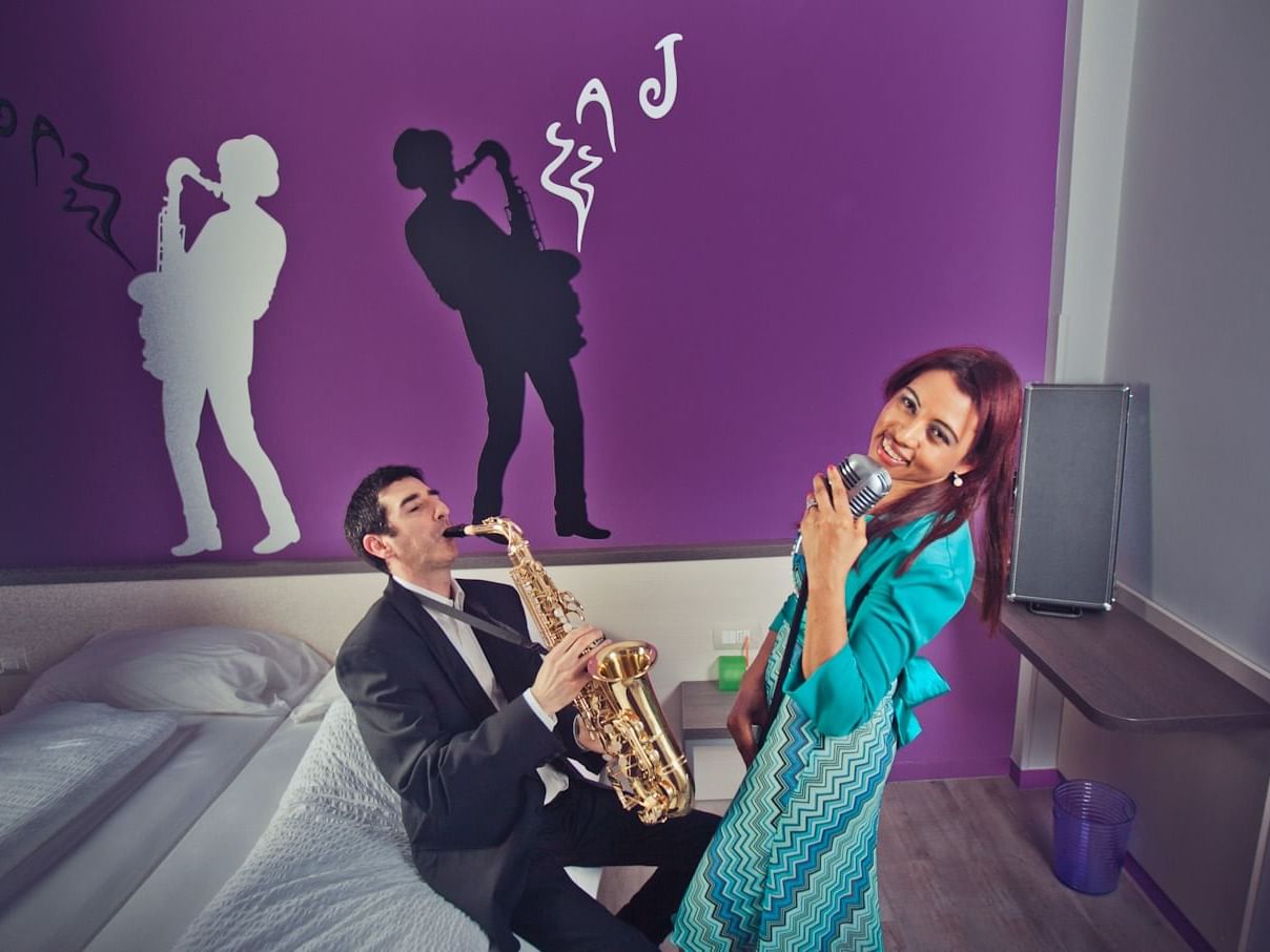 A couple plays music and sings inside Jazz room at Hotel Nologo