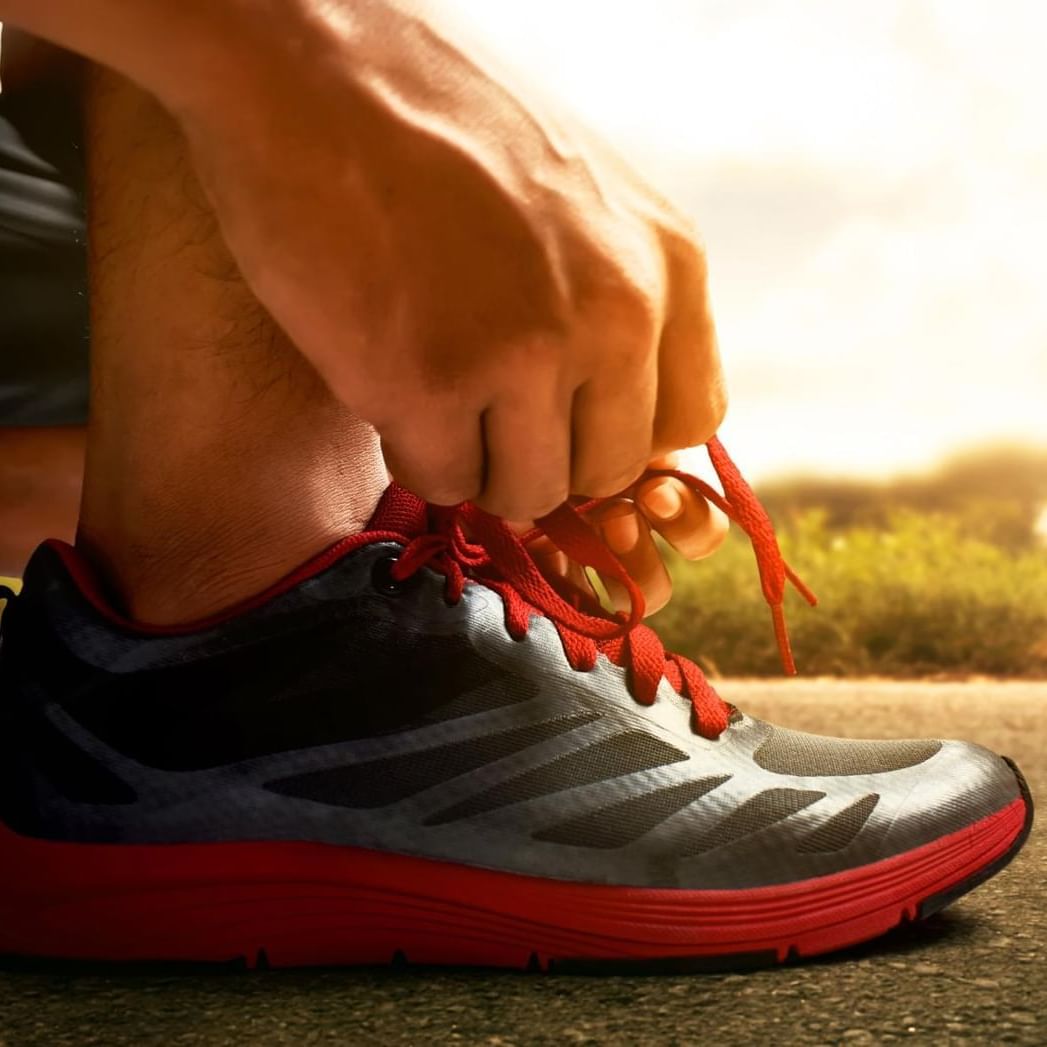 Man tying the laces on his running shoes