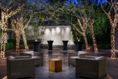 Luxe Terrace with illuminated tree decor arranged for a gathering at Luxe Sunset Boulevard Hotel