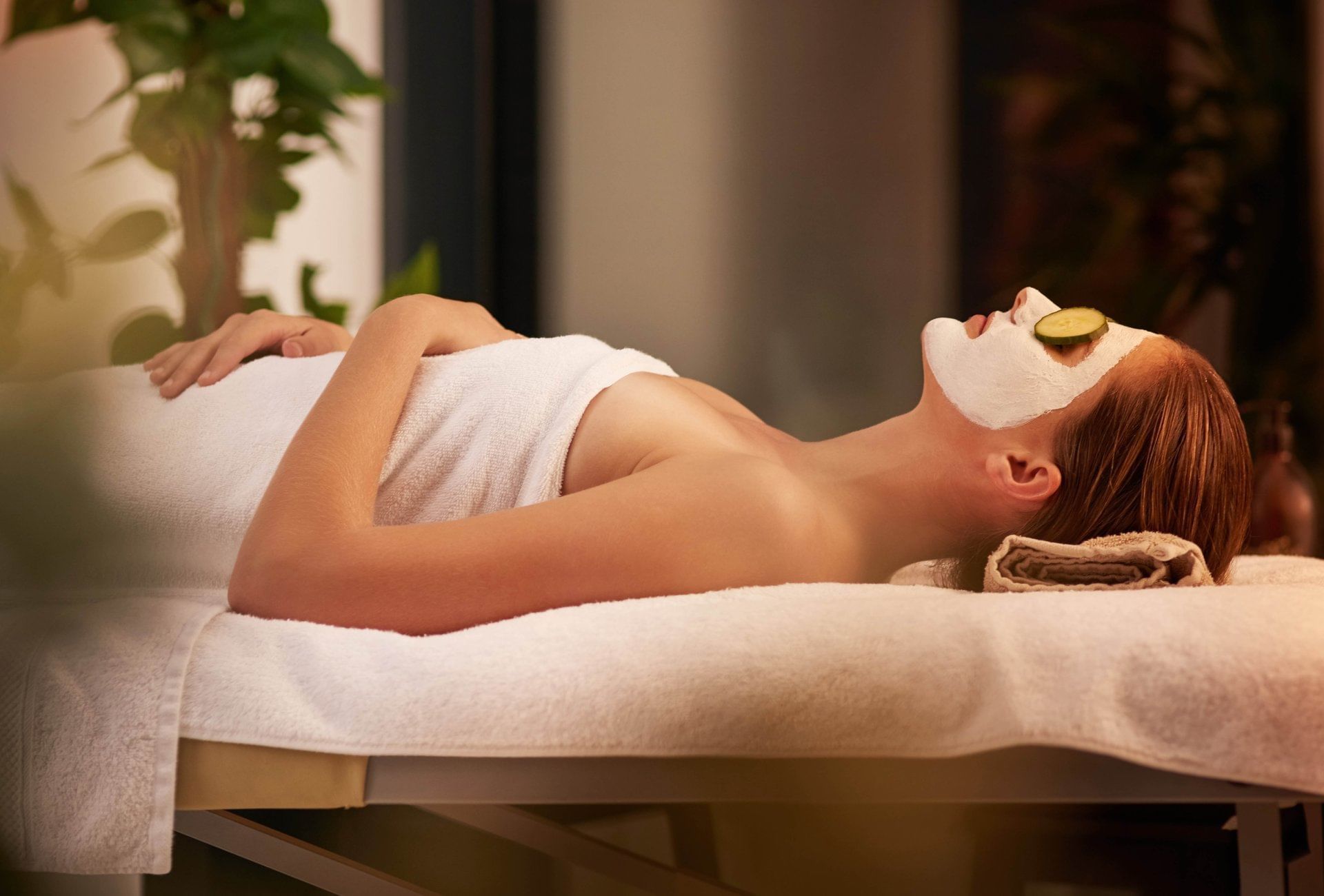 Lady with a facial laying on massage bed in Vie Spa at Pullman Port Douglas Sea Temple Resort & Spa