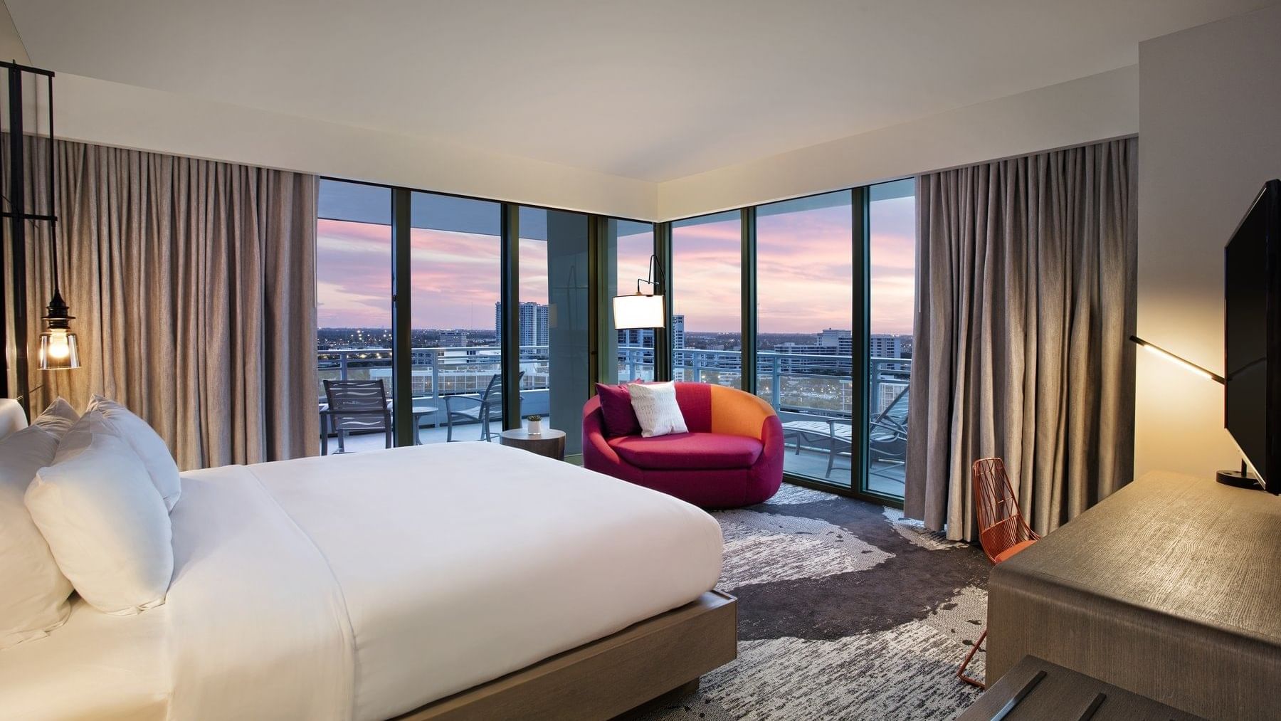 King bed & sofa with city view in Deluxe King Intracoastal View Wraparound Balcony at The Diplomat Resort