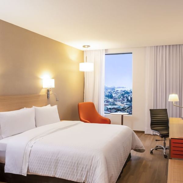 Interior of Superior Room with king bed & lounge at Fiesta Inn