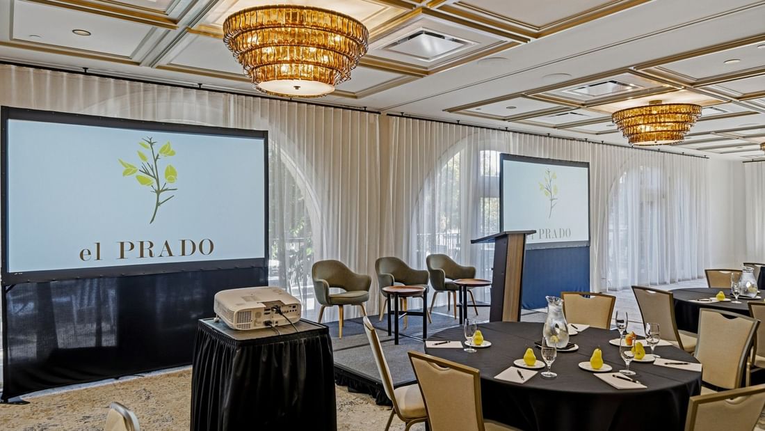 The La Terraza Ballroom event room at el PRADO Hotel in Palo Alto with chairs, projector, and table setup.