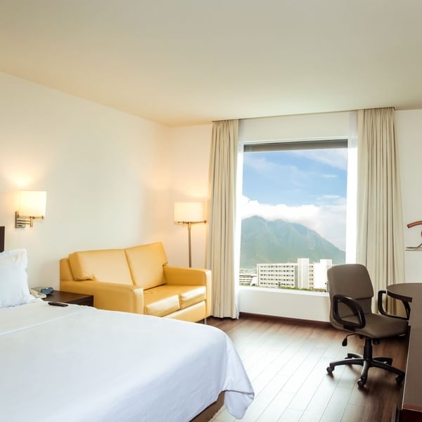 King bed & lounge in Executive Room with view at Fiesta Inn