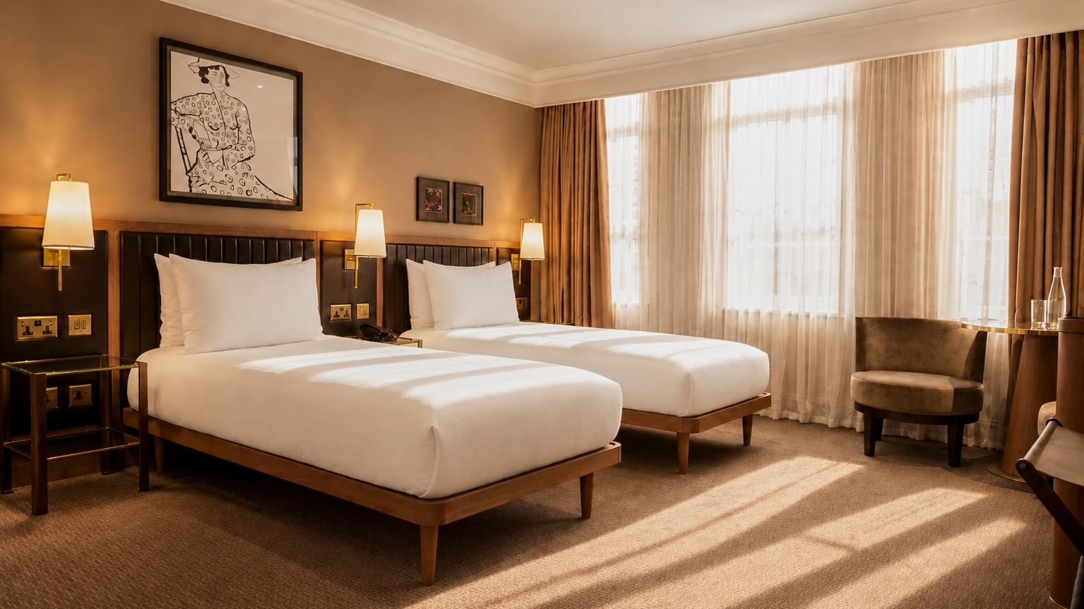 Collection Deluxe Twin Room with two beds, large windows, and warm lighting at The May Fair Hotel, London, England.