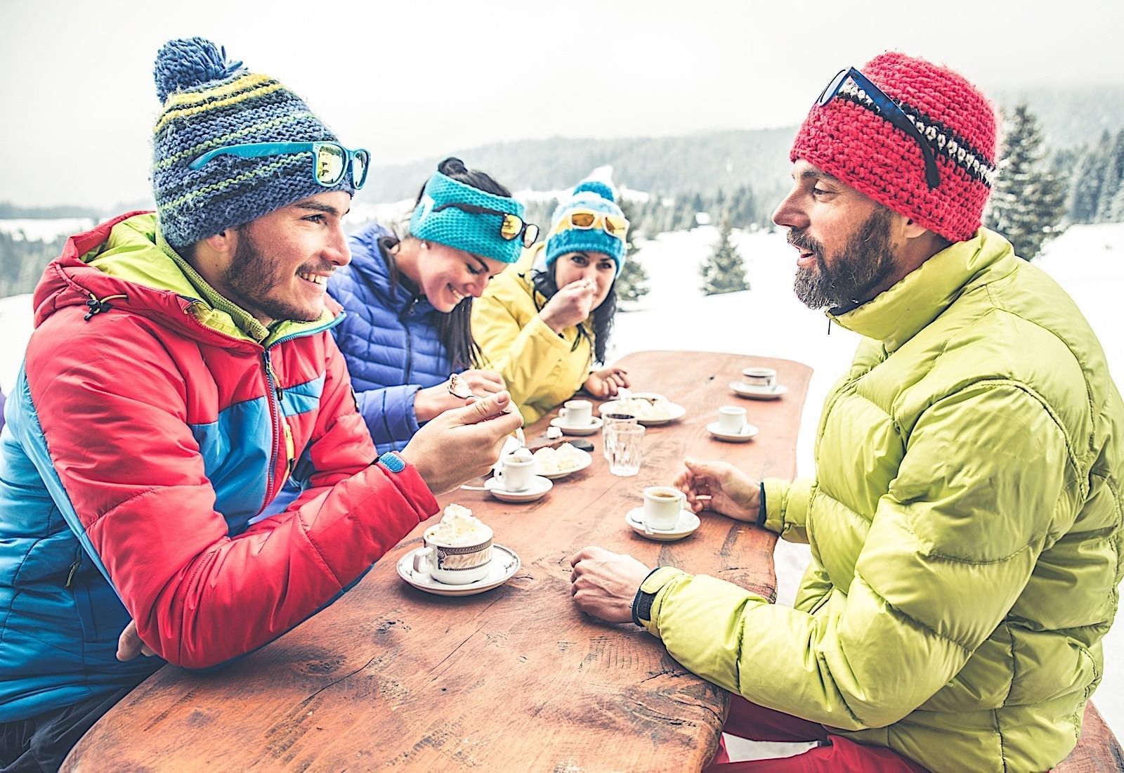 People in ski gear at picnic table