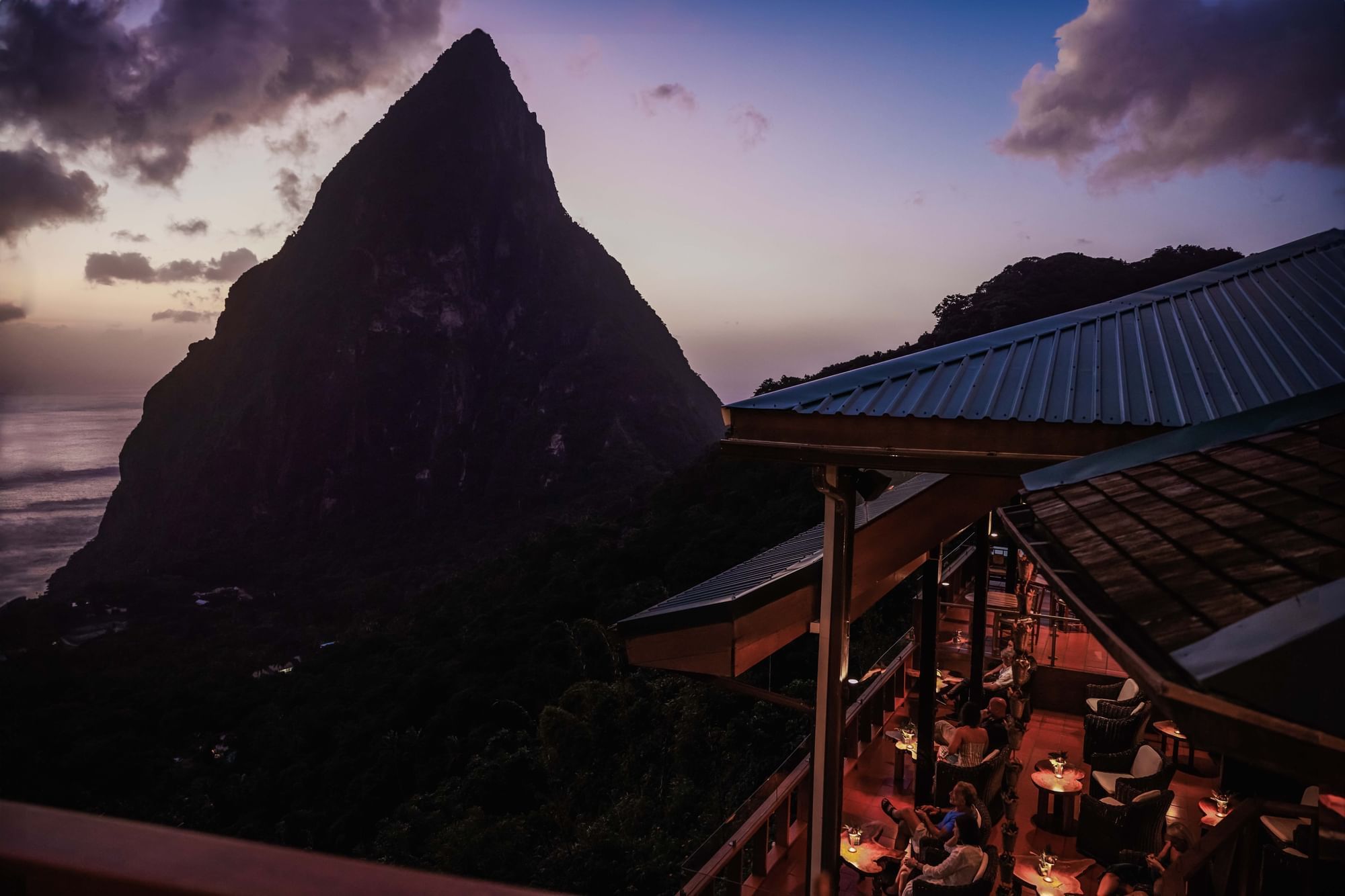 Distant view of the sunset in Gros Piton from the Dasheene Restaurant at Ladera Resort