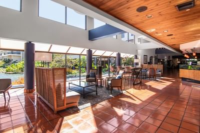 Hotel lobby with spacious patio and floor-to-ceiling windows at Miami Lakes Hotel