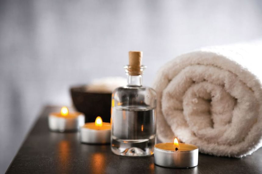 Spa oils by lit candles in J House Spa at J House Greenwich, CT hotel with contemporary design and spa
