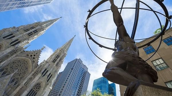 Low-angle view of ATLAS statue with buildings near Warwick New York