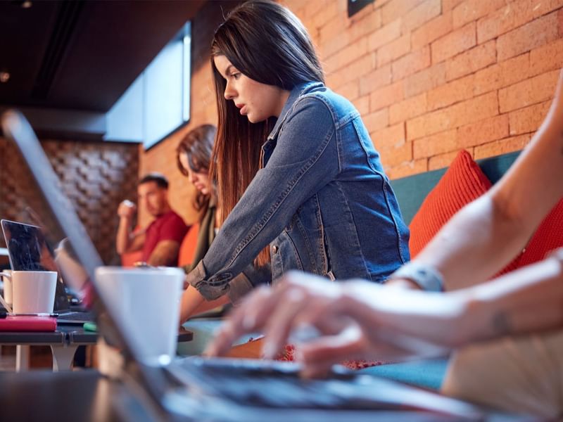 People working on laptops in a cafe near Fiesta Americana