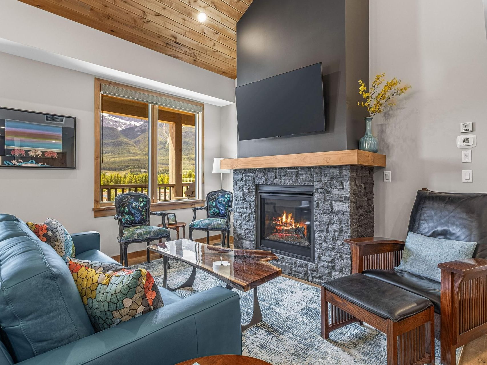 409 Timberstone Lodge One Bedroom Elevated Condo living area with a fireplace at Spring Creek Canmore Vacation Rentals