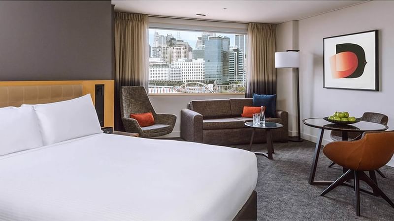 Queen-sized bed with Darling Harbour view in Executive Room at Novotel Sydney on Darling Harbour