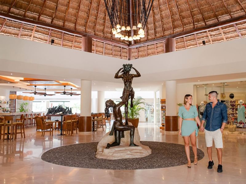 Couple walking through the Lobby of the Reef Coco Beach