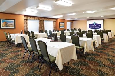 Diamond Room arranged with seating and a screen at Crystal Inn Salt Lake City