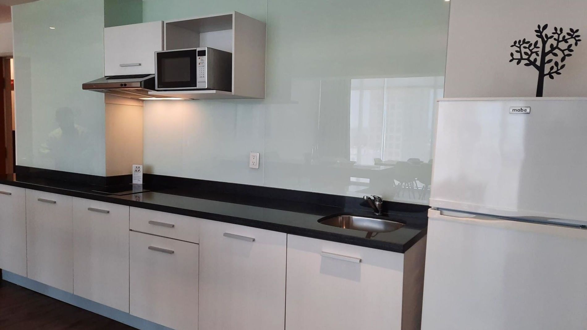 2 Double Suite 1 Room kitchen area with white cabinetry and a black granite counter at Camino Real Puebla Angelopolis