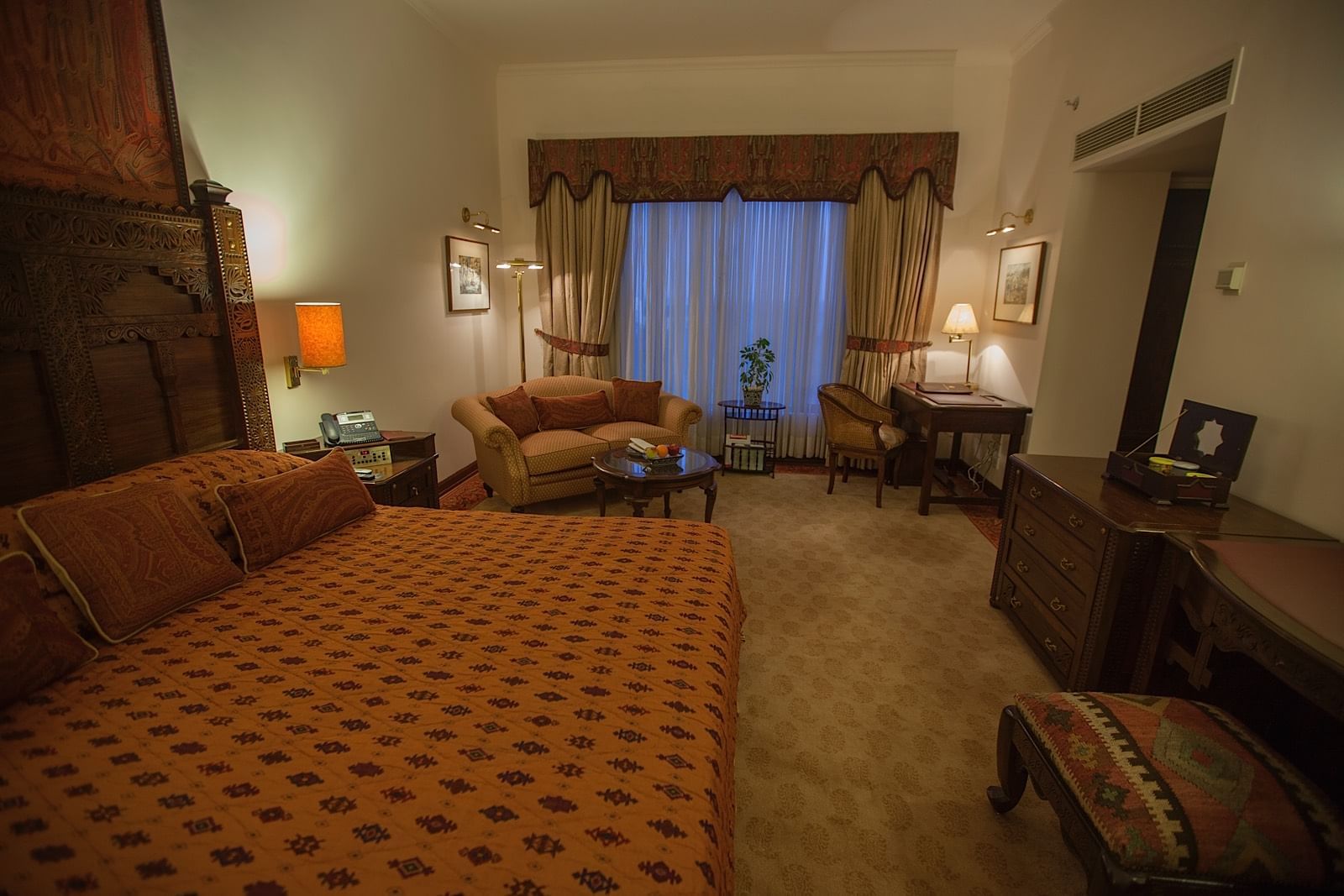 Bed & furniture in Deluxe Room at Islamabad Serena Hotel