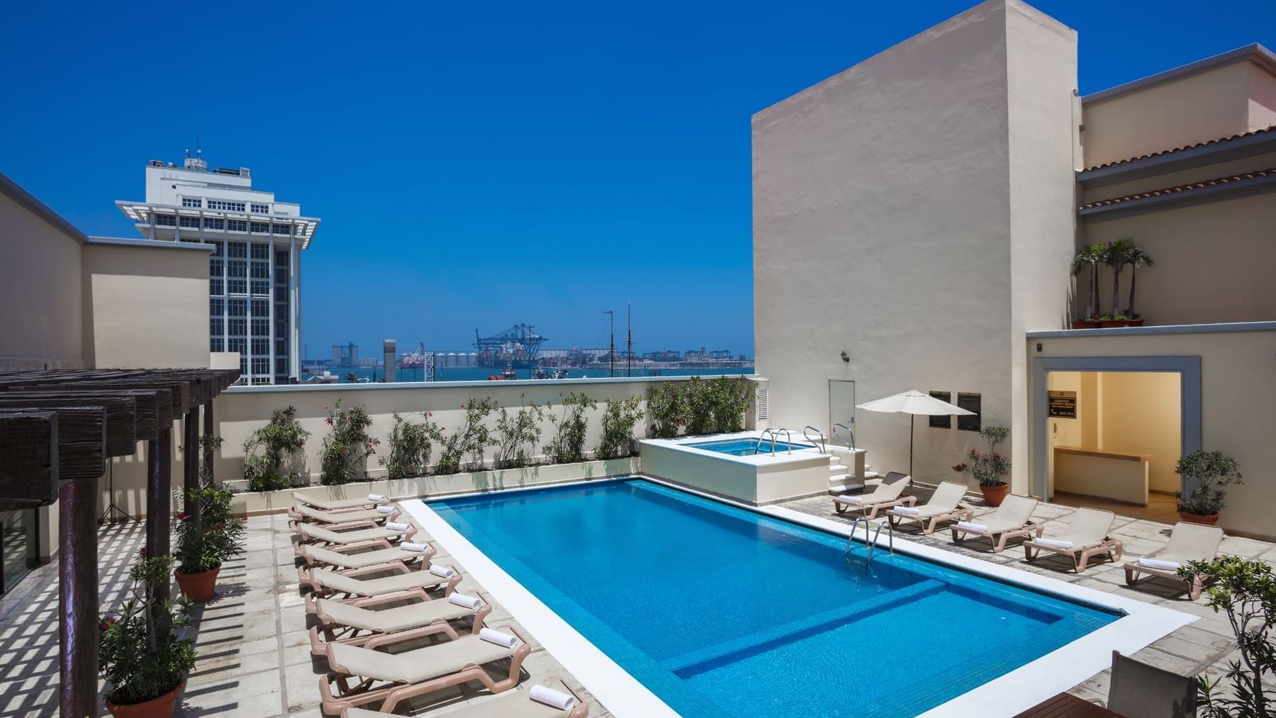Sunbeds by the outdoor pool at Fiesta Inn Veracruz Malecon