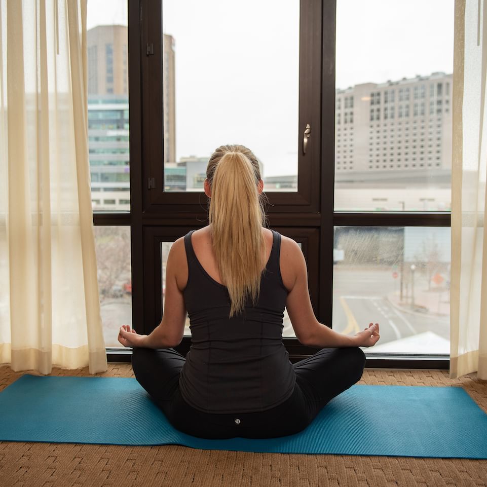 A woman doing yoga at Hotel 43