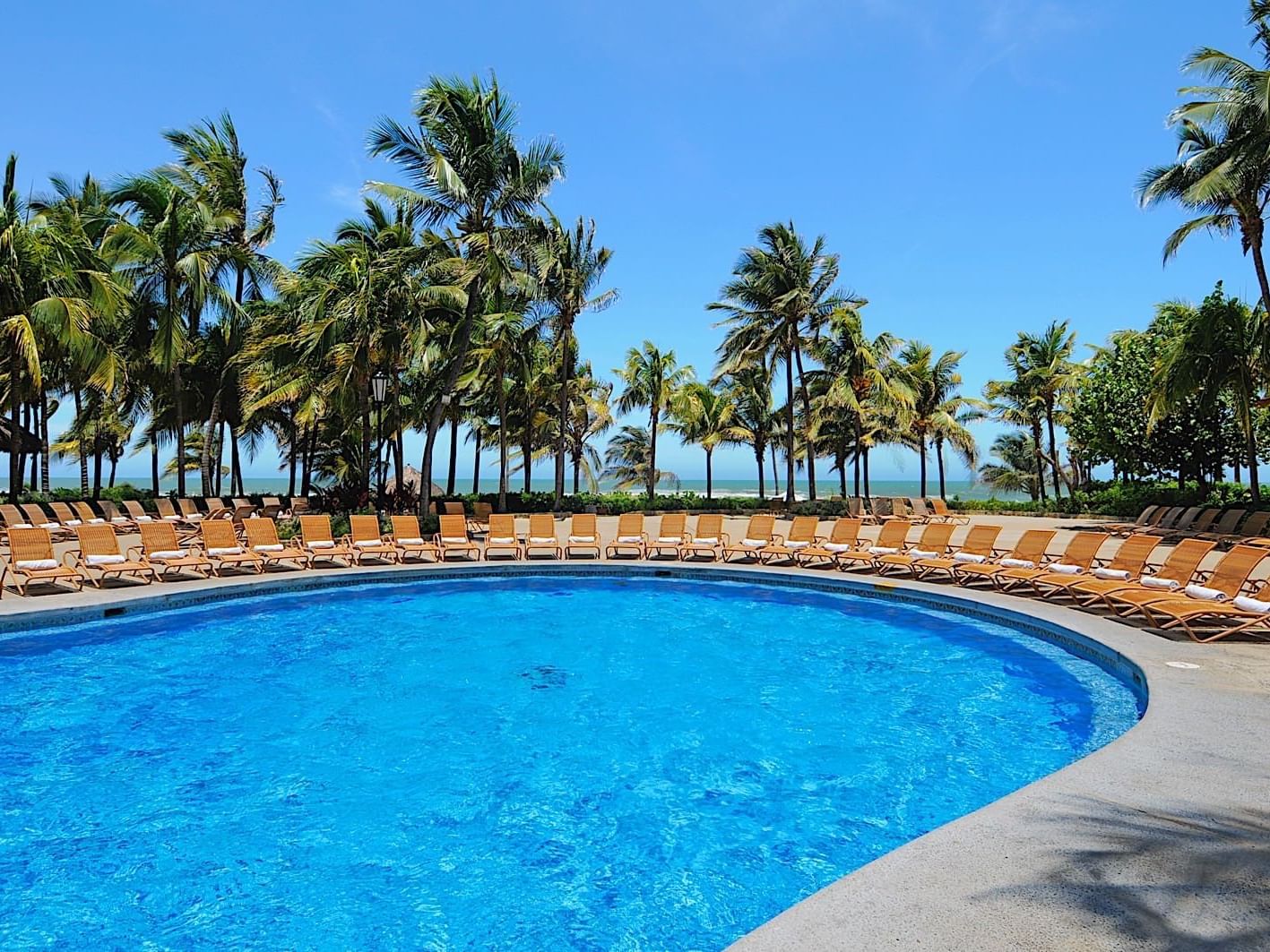 Outdoor pool with sunbeds at Princess Mundo Imperial
