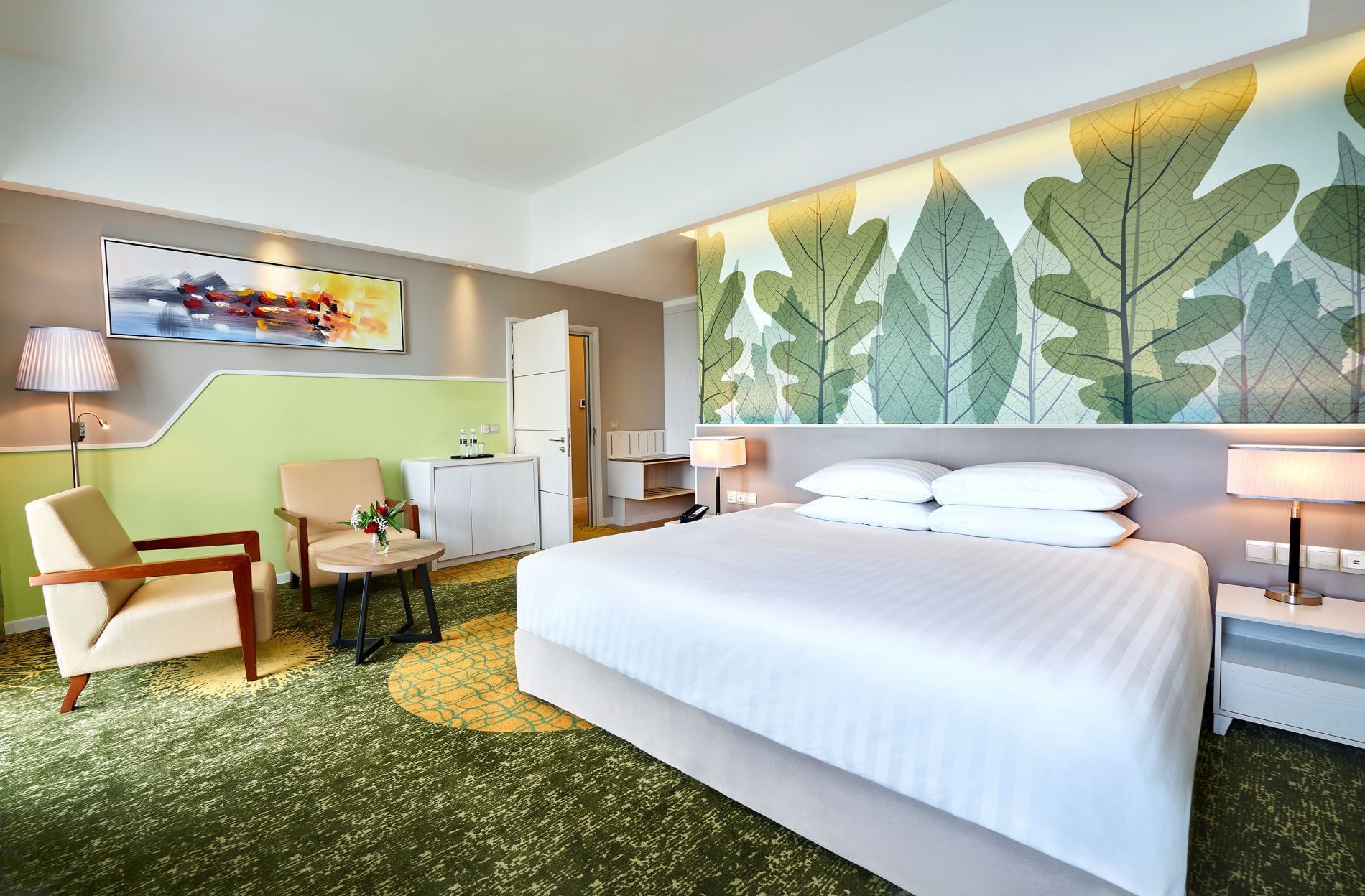 King-size bed with sitting area in Junior Suite at Sunway Velocity Hotel