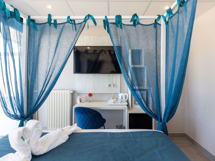 Bed with nets in Hotel Neptune at The Originals Hotels
