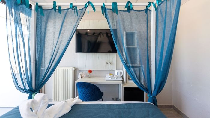 Bed with nets in Hotel Neptune at The Originals Hotels